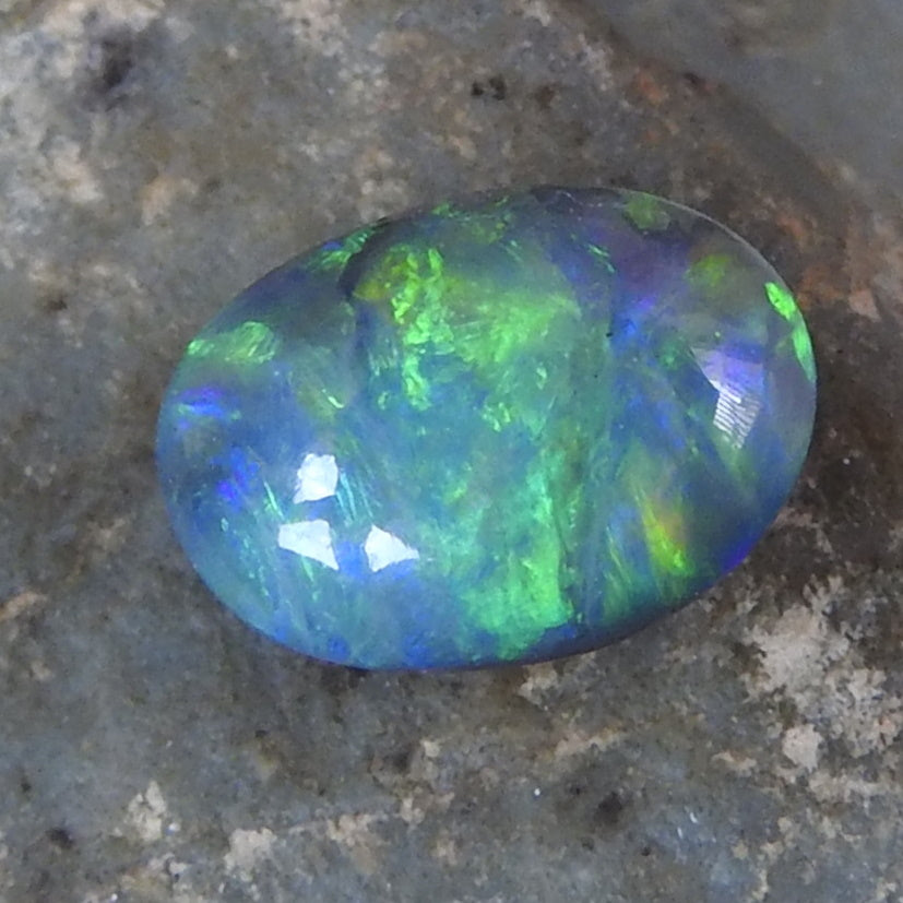 Lightning Ridge Solid Black Opal with Green Blue Yellow Colors.